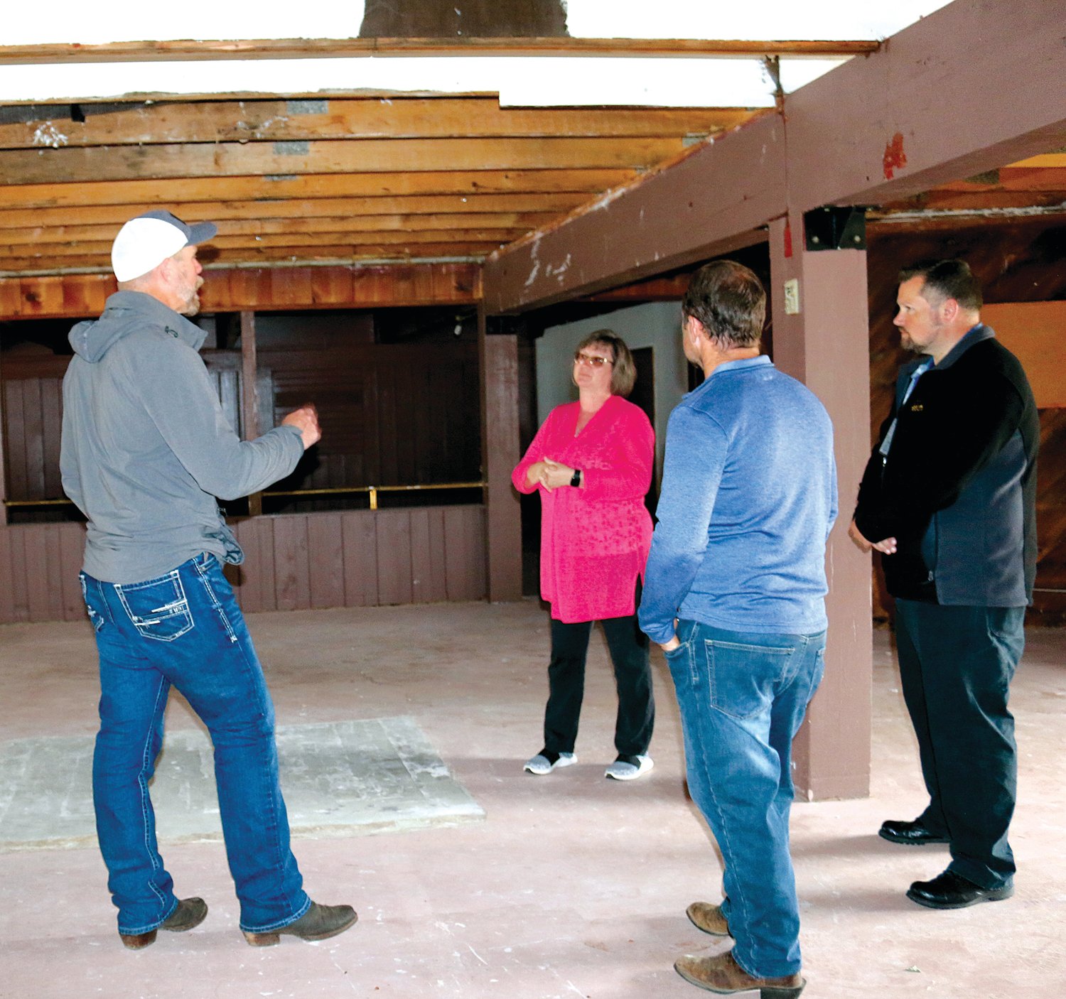 Property Developer Eric Oien of Fiddleback Properties, left, reviews the construction plans with Arbor Health CEO Leianne Everett, center, while Property Developer Brandon Hamrick and Arbor Health Facilities Director Matthew Lindstrom look on.